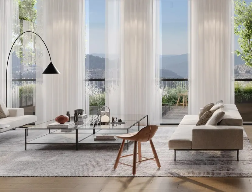 Bright lounge with sheer curtains, glass coffee table and mountain views